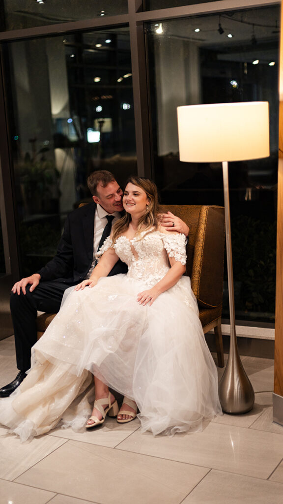 Couple cuddling beside a warm lamp—five-minute night portrait.